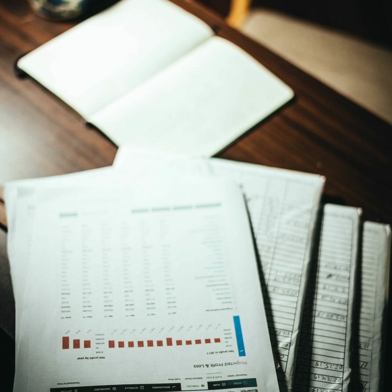 Pile de documents comportant des données statistiques posée sur un bureau